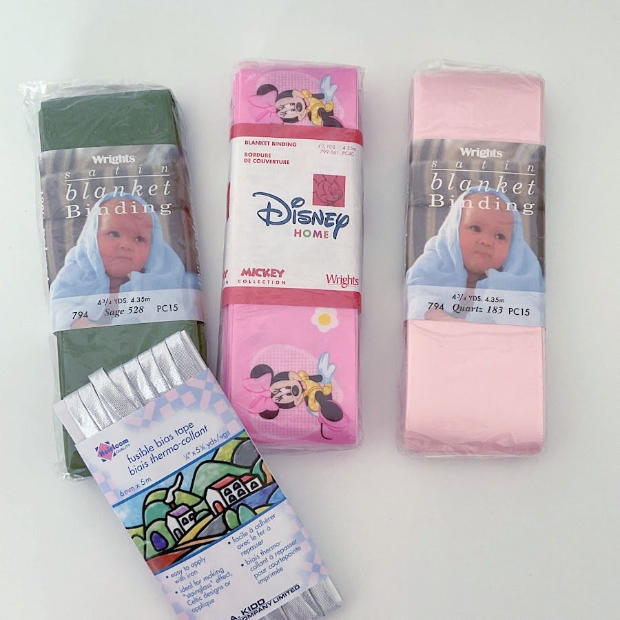 four packages of binding tape of various colors and widths