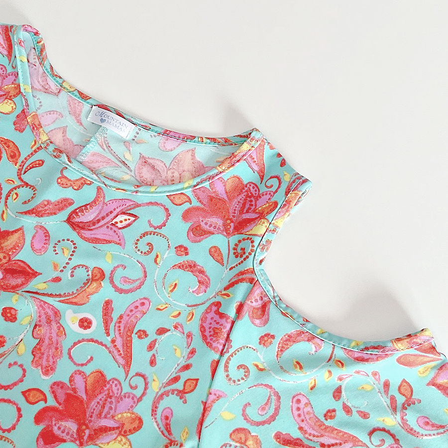 bias binding around the neck line and arm holes in a blouse with floral motif fabric