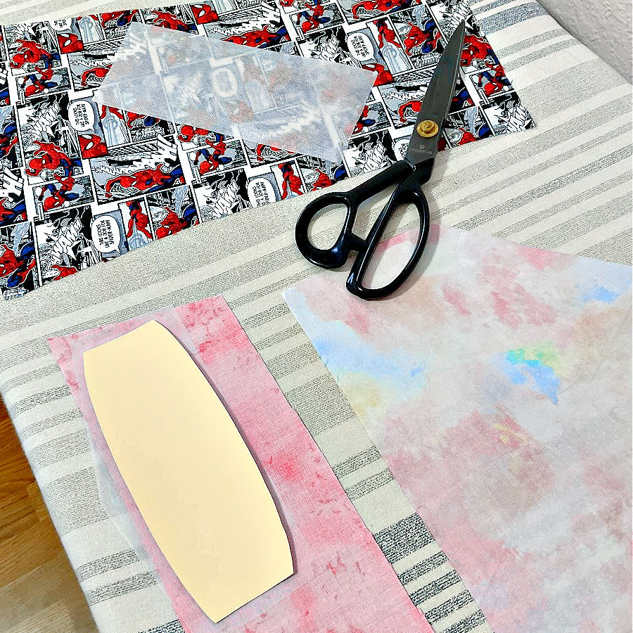 a pair of scissors sitting on a piece of material with interfacing about to be applied