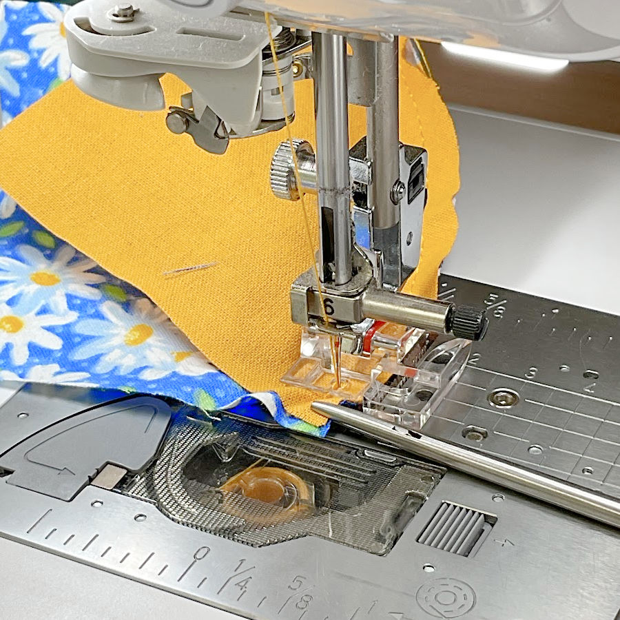 image shows the misalignment at the end of the curved stitch likely caused by the different amount of stretch in the two fabrics which because it is very small can easily be controlled while sewing