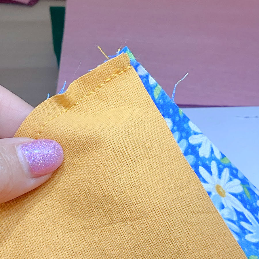 two pieces of fabric after sewing the curved seam are off by a very small amount due to different stretch properties