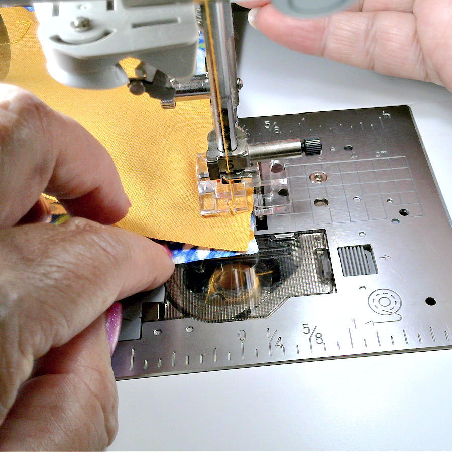 image showing the end of the seam where it becomes more difficult to align the two materials and tweezers or other tools are needed to guide the fabric