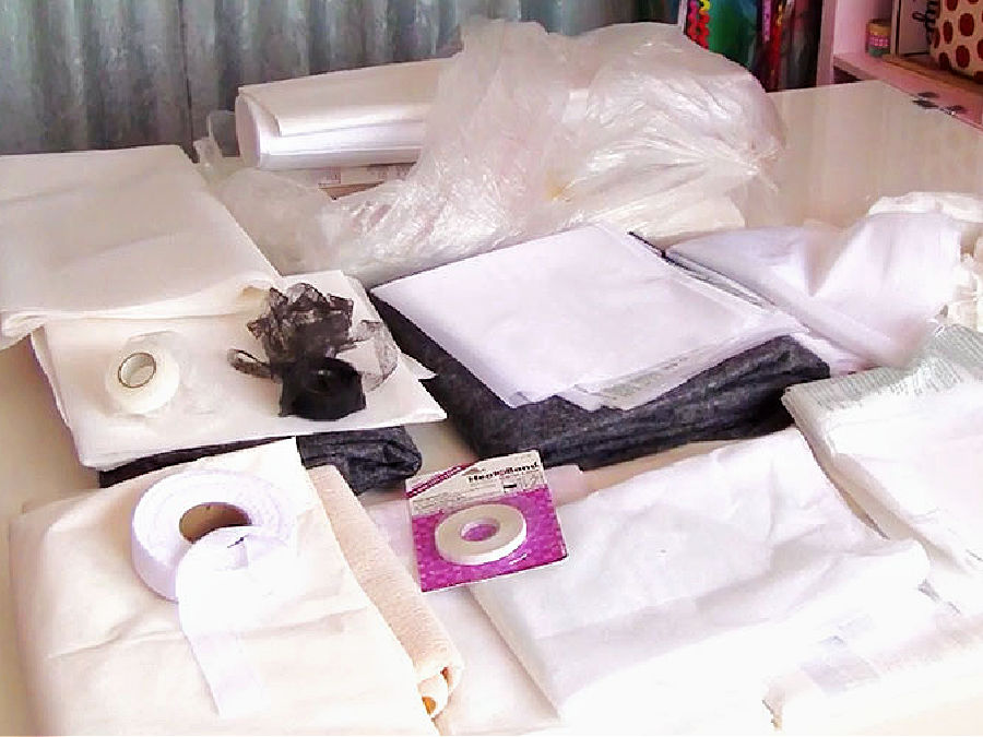 various types of interfacing shown on a table to illustrate the multitude of choices