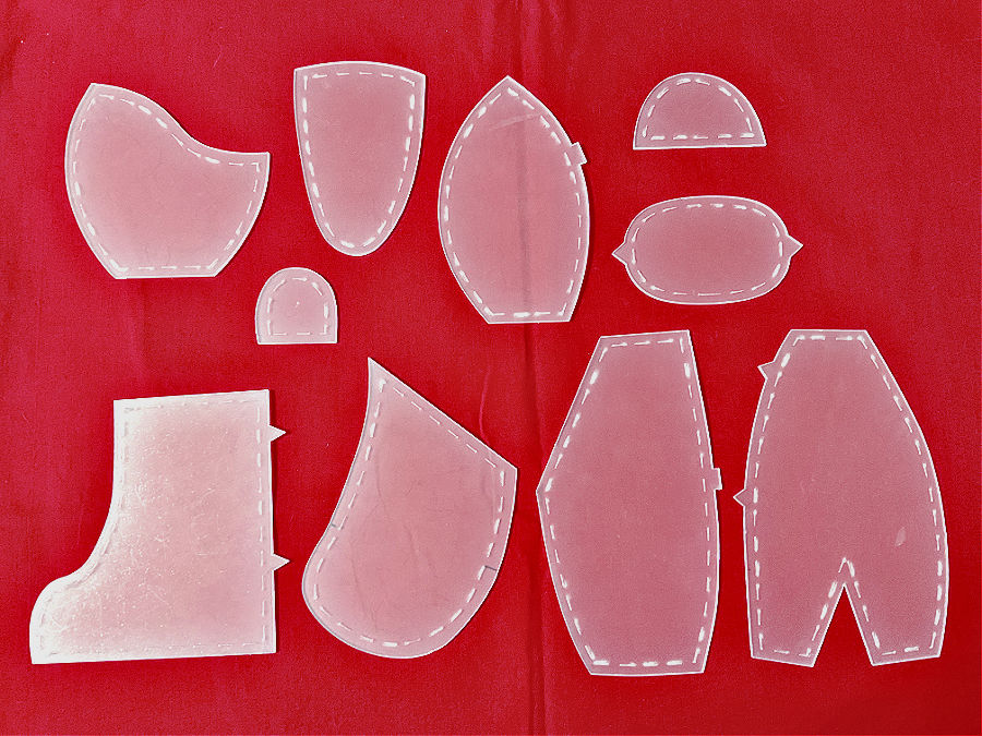 plastic shapes for a bear template on a red piece of fabric