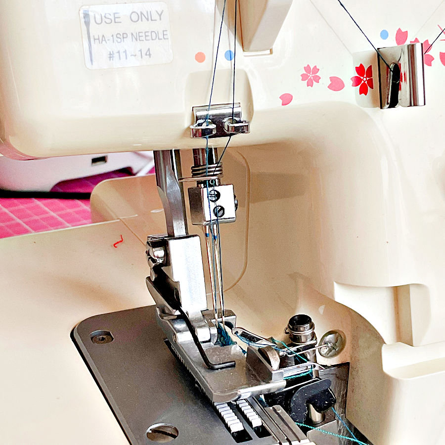 the needle assembly of a serger overlock machine with the note "use only HA-1SP needle #11-14"