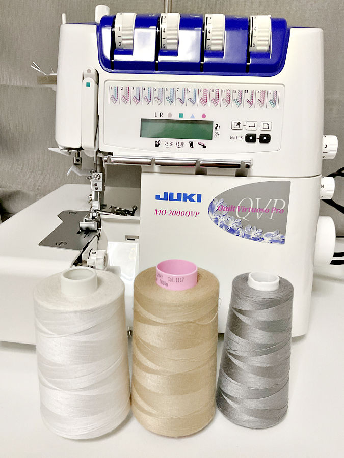 image of a juky mo-2000qvp serger with three cones of thread in front of it