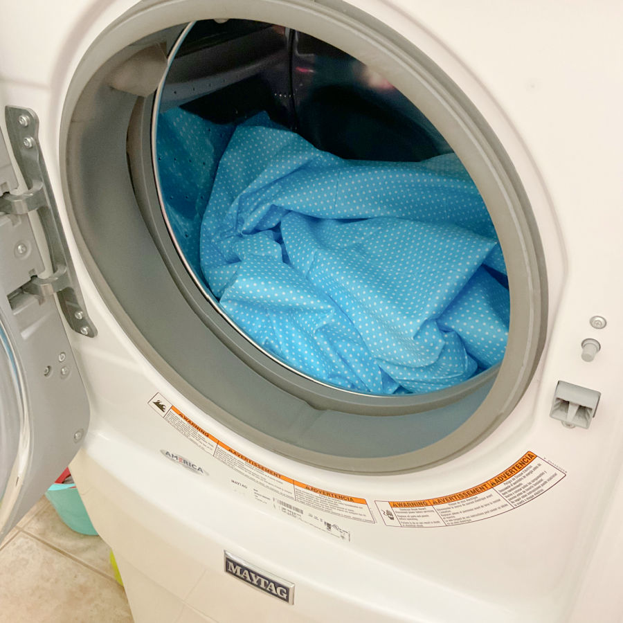 blue fabric with white dots inside a maytag washing machine