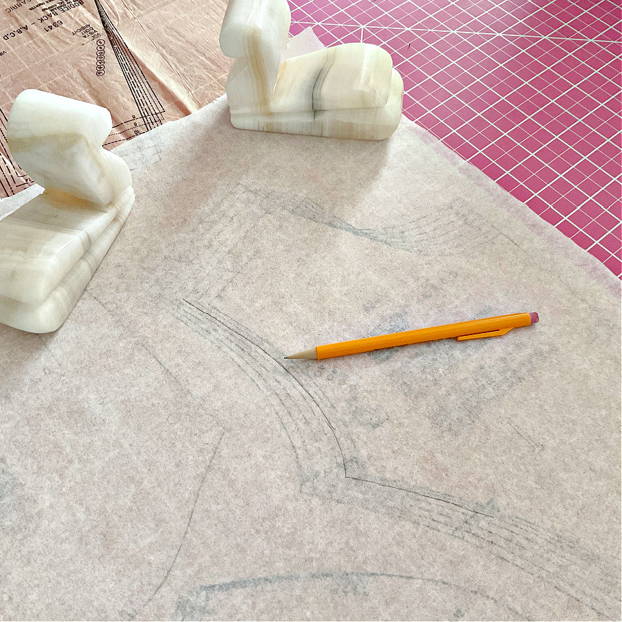 two marble book ends used as pattern weights while tracing a pattern on semi transparent tracing paper