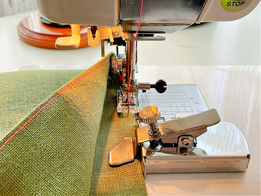 the magnetic seam guide installed on a sewing machine at the proper distance for a straight stitch at 1/8" distance from the edge of the fabric