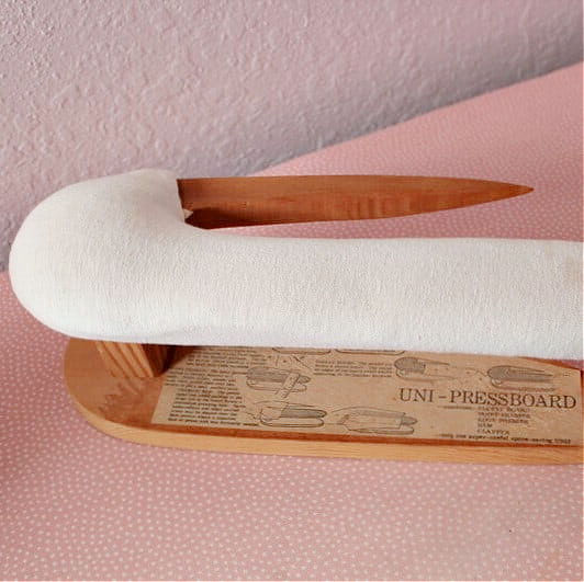 point presser and tailors board sitting on an ironing board