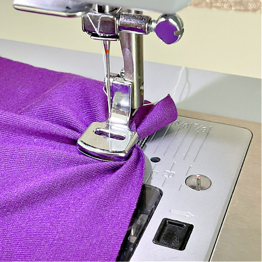 gathering foor being used on a piece of purple rayon knit fabric