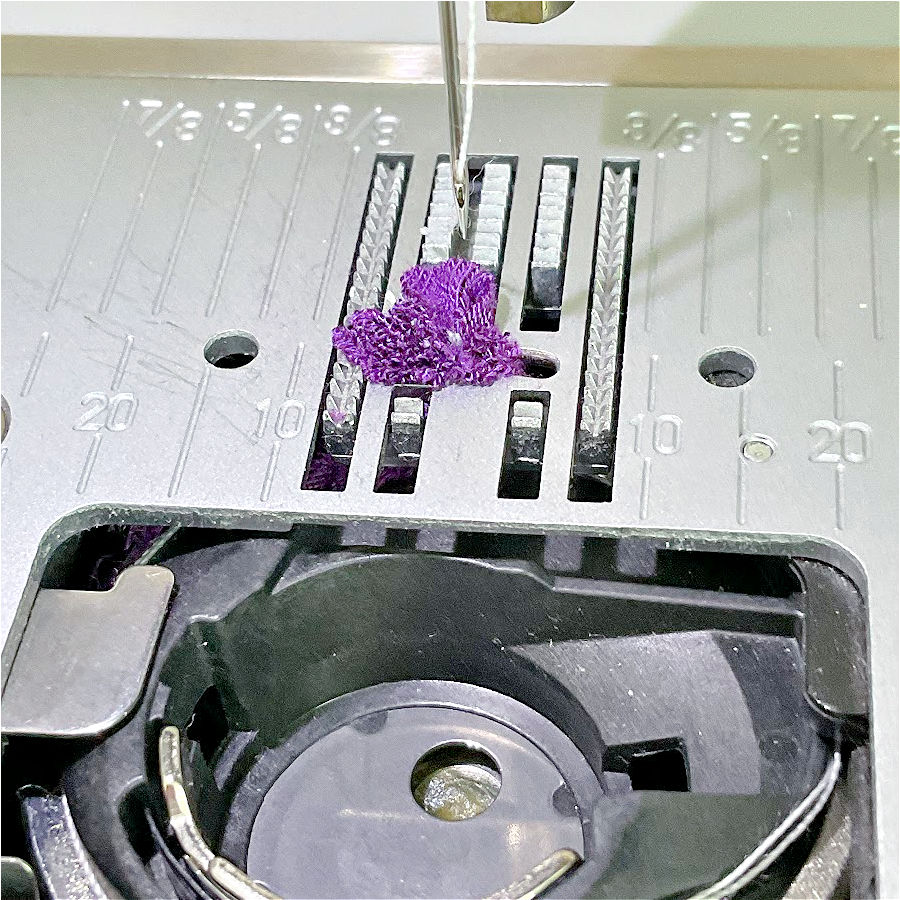 a piece of fabric stuck inbn the sewing machine after using the gathering foot