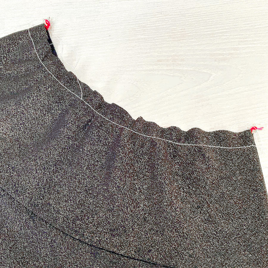 a piece of thicker knit fabric after using the gathering foot shows good gathers