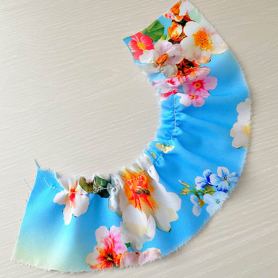 gathering foot used on a piece of multi colored polyester crepe with tension 5 and stitch length 3 produces very good results