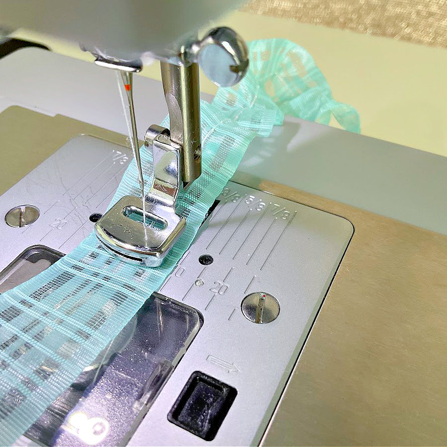 gathering foot working on a piece of organza ribbon