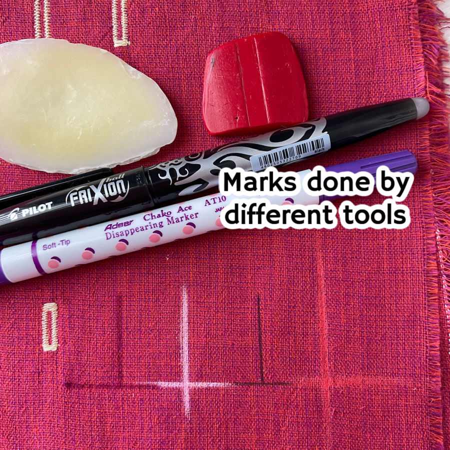 chalk soap frixion pen and disappearing marker pen of various colors shown on a piece of red fabric with the marks they make on the fabric