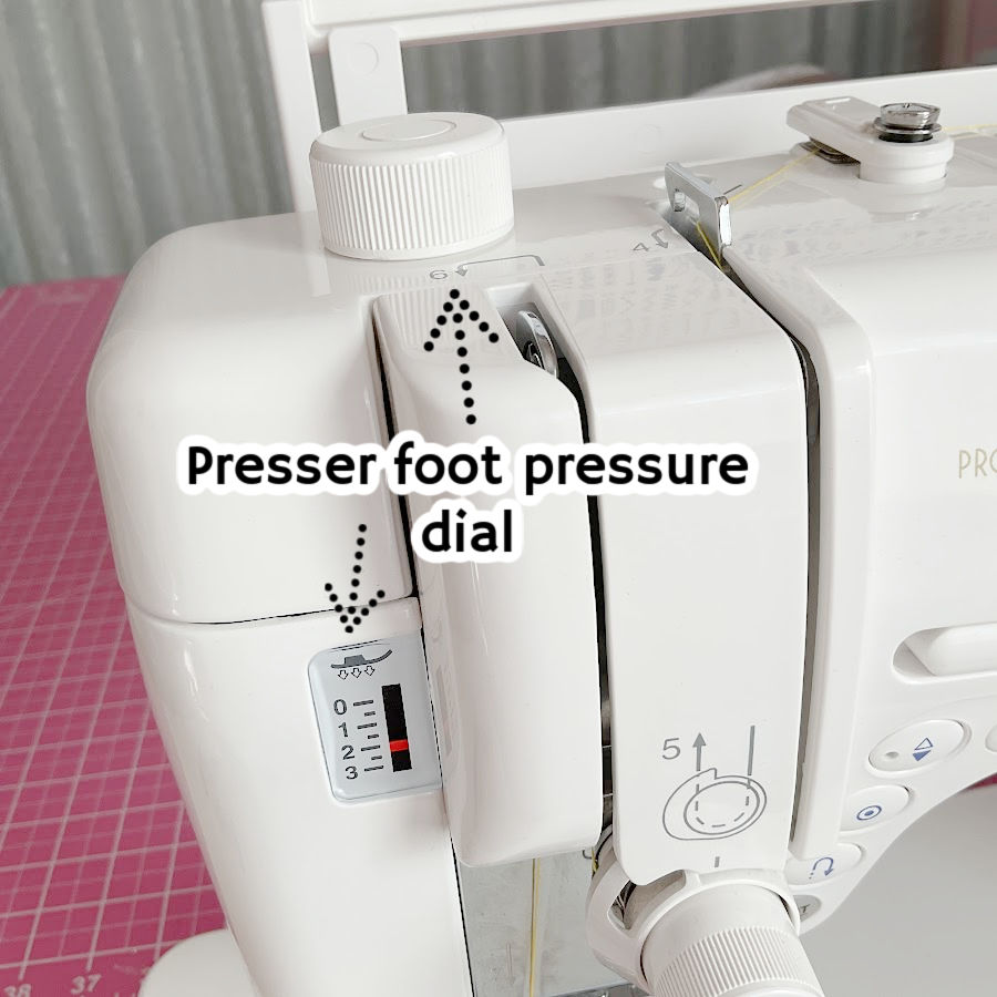 the top of a sewing machine with the pressure foot pressure dial and gauge in the foreground highlighted by arrows