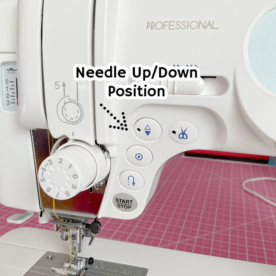 a sewing machine front panel detail with the needle up down button highlighted by an arrow the text needle up down position superimposed on the image
