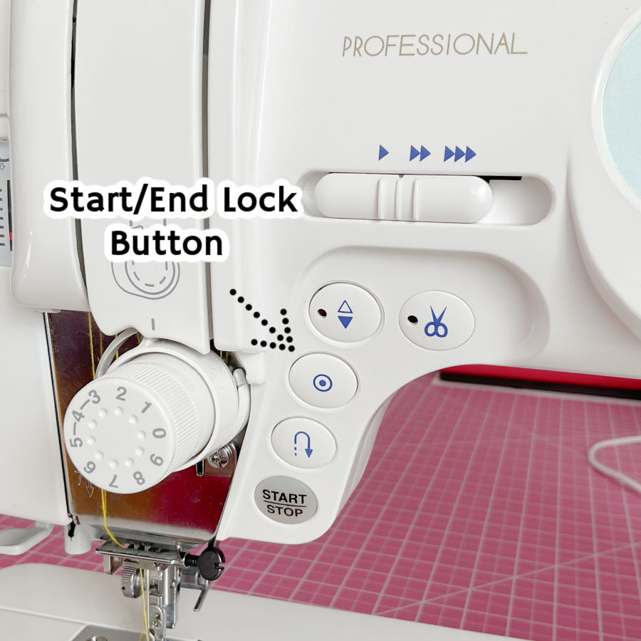 a janome sewing machine front panel detail with the start end lock button highlighted by an arrow