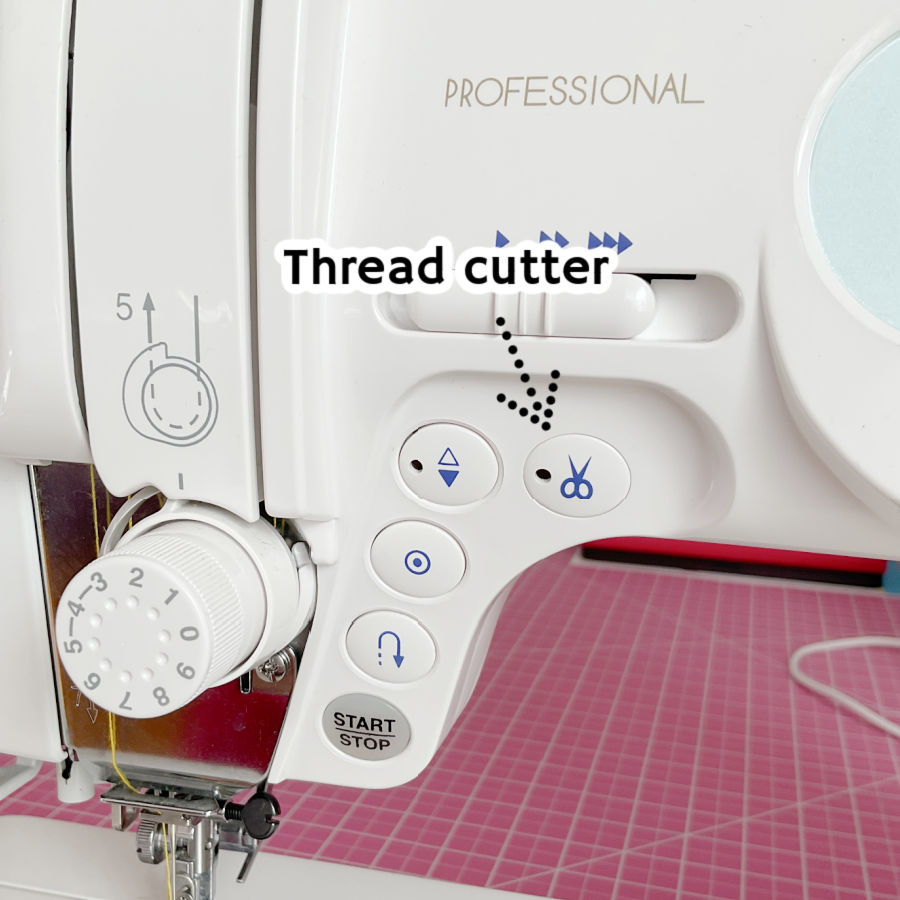 the front of a sewing machine with a number of buttons an arrow pointing at a button with an icon of a pair of scissors and the text thread cutter superimposed on the image