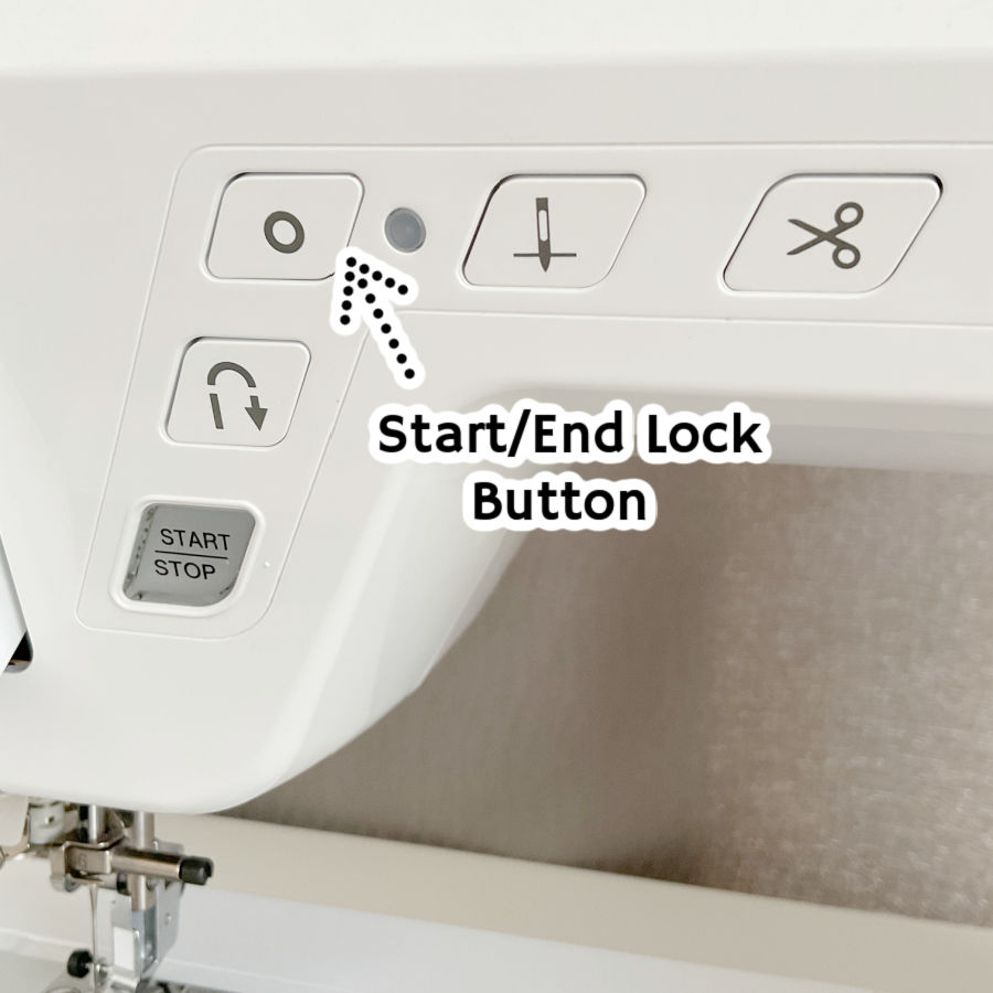 a sewing machine front panel detail with the start end lock button highlighted by an arrow