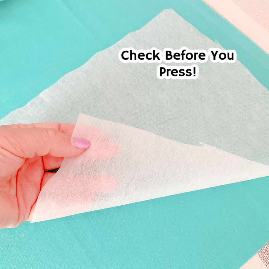 a womans hand turning a piece of interfacing the text "check before you press" superimposed on the image