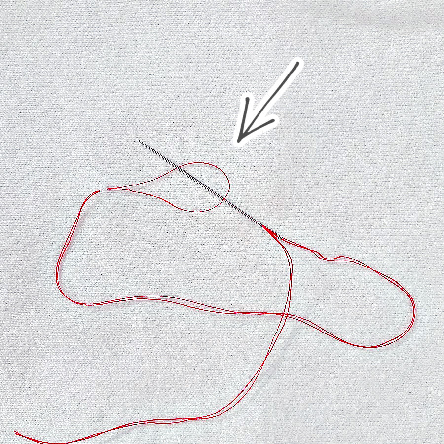 double thread knot step 3 pass the needle through the loop