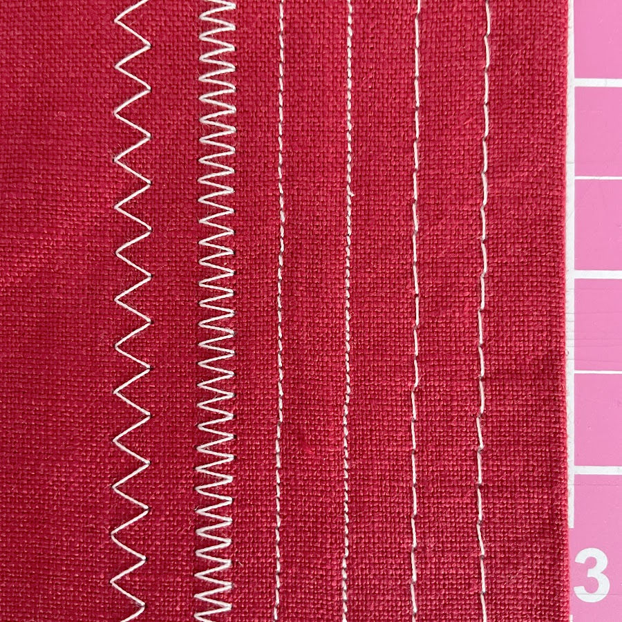 a close up of a piece of fabric with multiple zig zag and straight stitches with different stitch lengths
