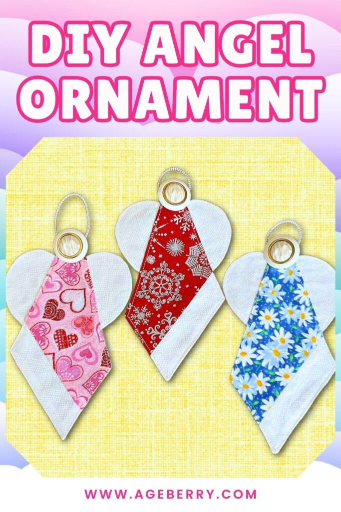 Three handmade DIY angel ornaments made from fabric, each with white wings, a small round button as the head, and a silver loop for hanging. The bodies feature different prints: pink with hearts, red with snowflakes, and blue with daisies.