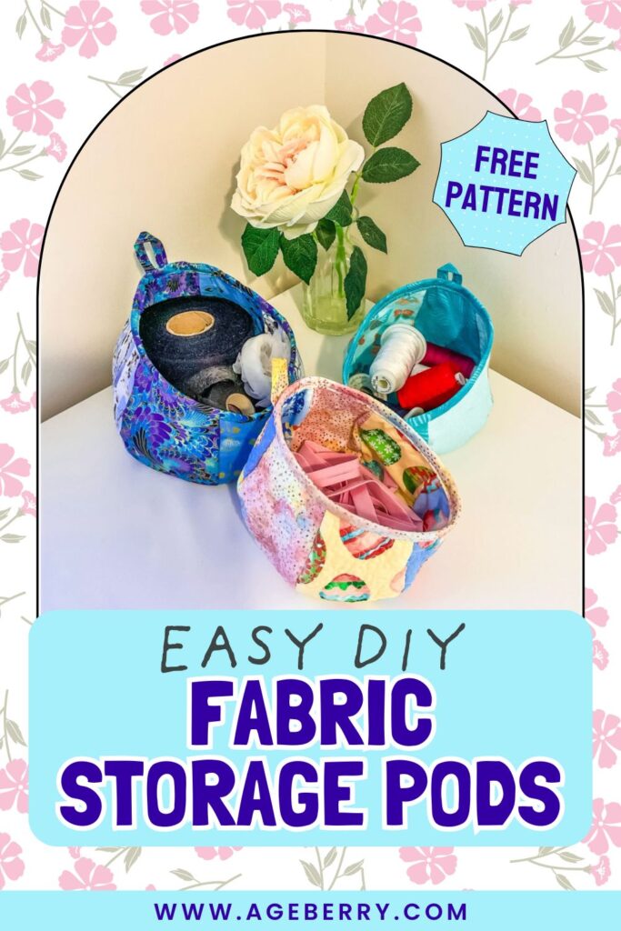Three colorful quilted fabric storage pods filled with sewing supplies like elastic, thread spools, and trims, displayed on a white surface next to a glass vase with a large white rose.