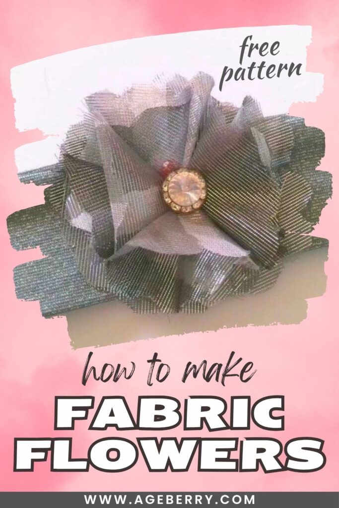 Handmade fabric flower crafted from shimmery silver fabric with layered petals and a rhinestone button center.