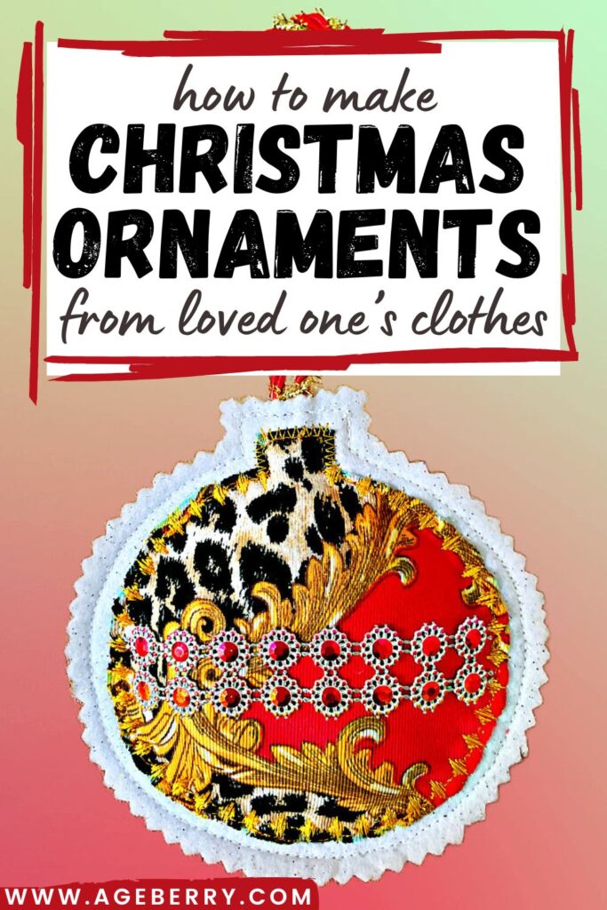 Handmade Christmas ornament created from upcycled clothing fabric in red, black, and gold patterns with rhinestone accents. The ornament is trimmed with white lace and has a red hanging loop.