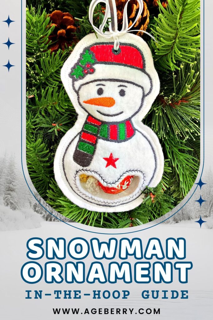 Embroidered in-the-hoop snowman ornament made from white felt, decorated with a red hat, green and red striped scarf, orange carrot nose, and stitched black eyes and smile. A red star embellishment is on its body, with a clear vinyl pocket holding wrapped candies. Ornament hangs on a silver ribbon against a green pine tree background.