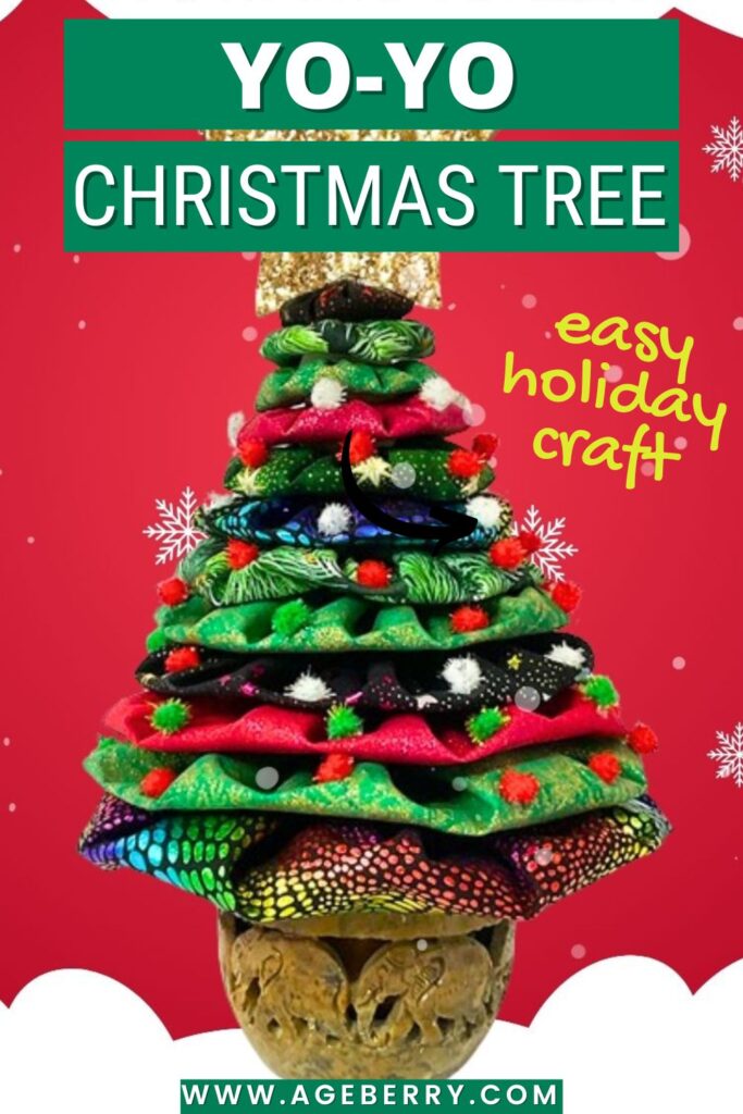 Handmade yo-yo Christmas tree crafted from stacked fabric yo-yos in red, green, black, and multicolor prints, decorated with small pom-poms, and displayed in a carved wooden base.