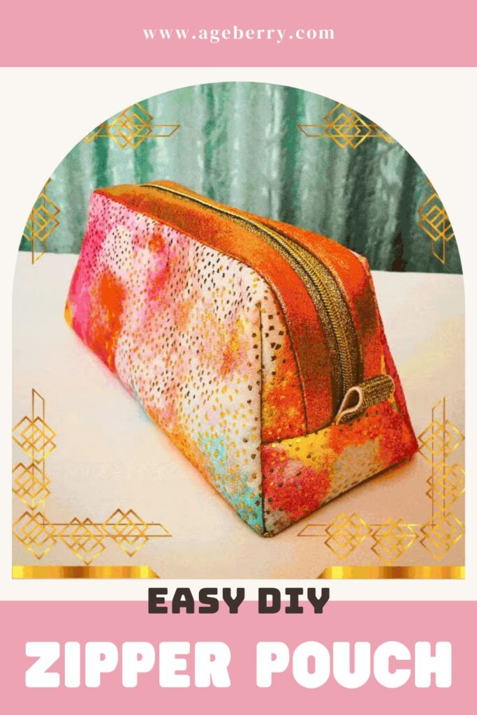 A colorful rectangular zipper pouch in bright orange, pink, yellow, and turquoise tones rests on a white surface. The pouch has a metallic gold zipper and structured sides.