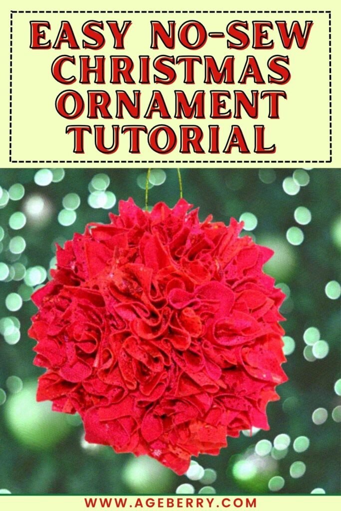 Red no-sew Christmas ornament made from layers of ruffled fabric pieces forming a festive ball shape, hanging on a blurred background of Christmas lights.