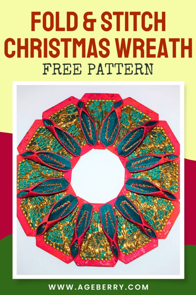Fold and stitch fabric Christmas wreath made from folded red, green, and gold printed fabrics, arranged in a circular petal-like pattern with stitched details and red bead embellishments.