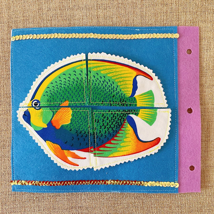 a page of the quiet book showing a 4 piece fish puzzle assembled properly