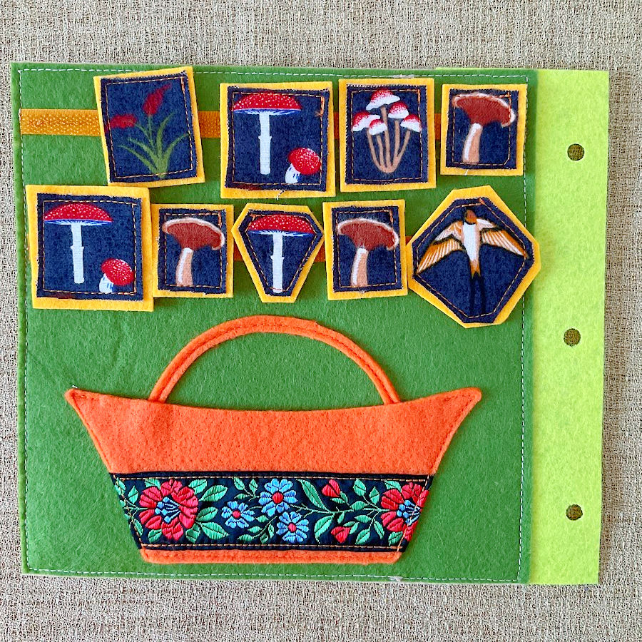 a page from the quiet book showing a basket and mushroom shapes that need to be arranged in the basket