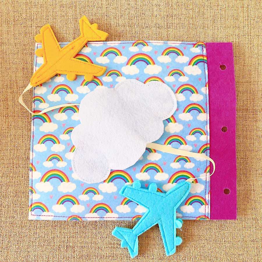 a page of the quiet book showing two airplanes flying around a cloud