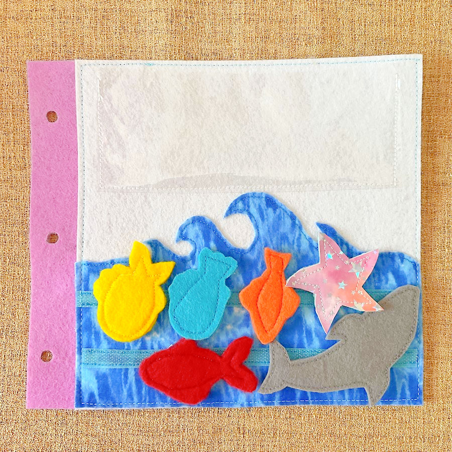 a page of the quiet book showing the sea with the marine animals now in the water