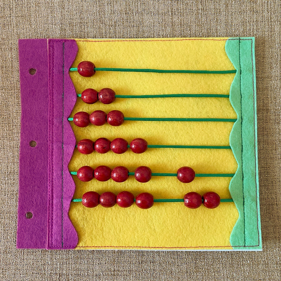 simple abacus made out on a quiet book page from beads and cords