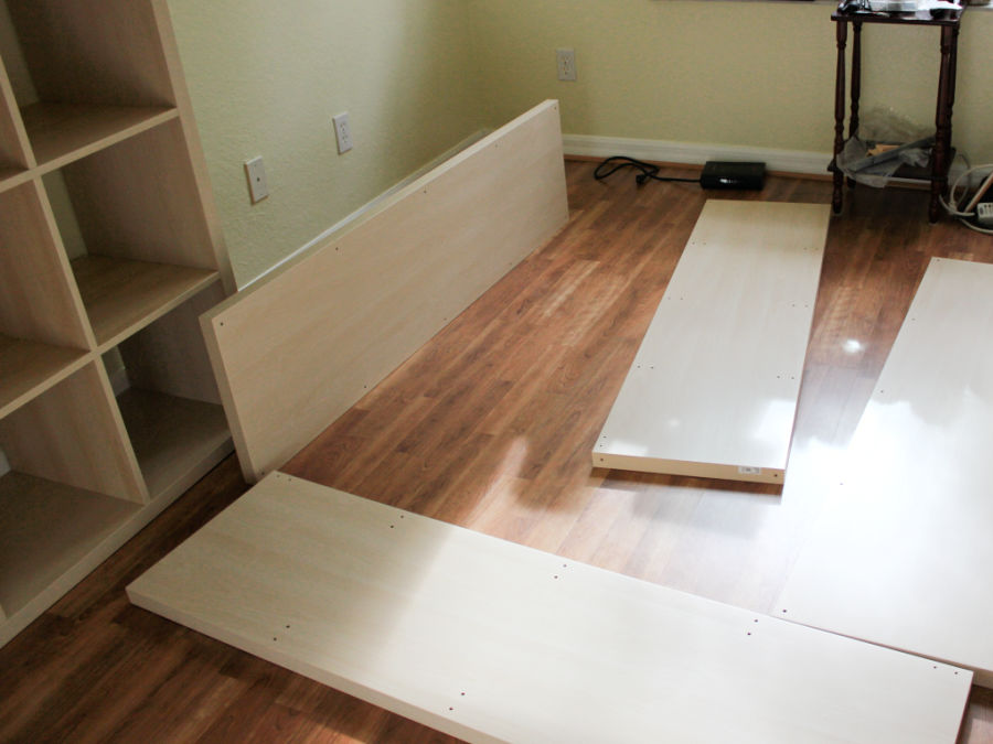pieces of IKEA furniture in various states of assembly in what will be a future sewing room