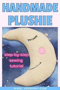 A handmade plushie moon toy made from soft cream-colored plush fabric with embroidered eyes and a pink cheek. The moon rests on a blue starry sky background with the text “step-by-step sewing tutorial.”