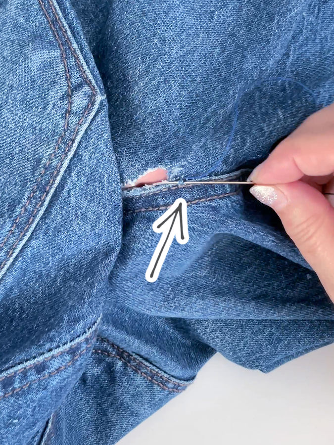 inserting the needle on the other side of the hole using a healthy part of the material not affected by the rip