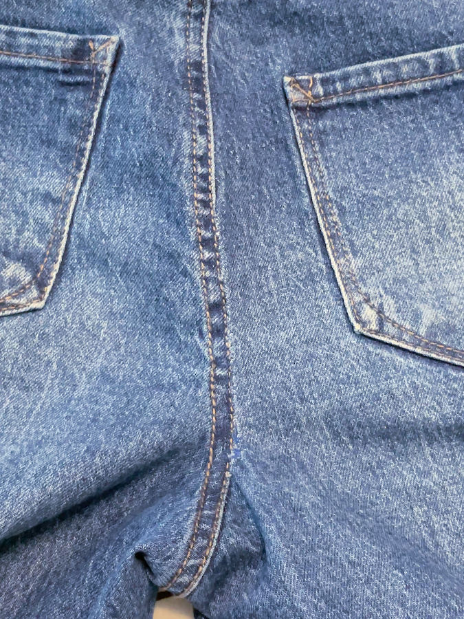 the back seam of the jeans after repair and pressing
