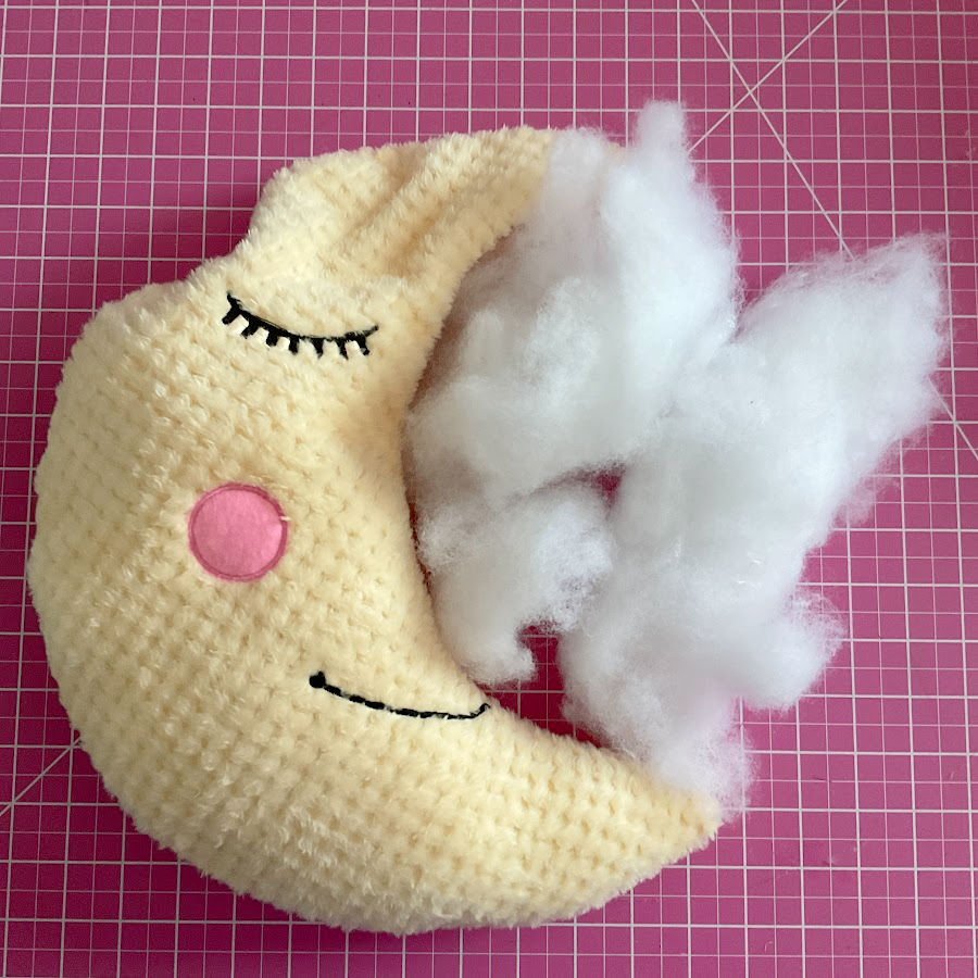 the moon toy plushie while being stuffed with poly-fil