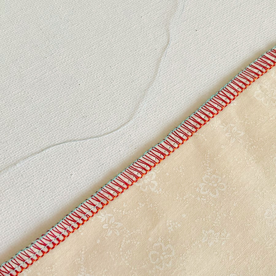 a portion of the right needle thread removed from the seam the left needle thread still in the seam