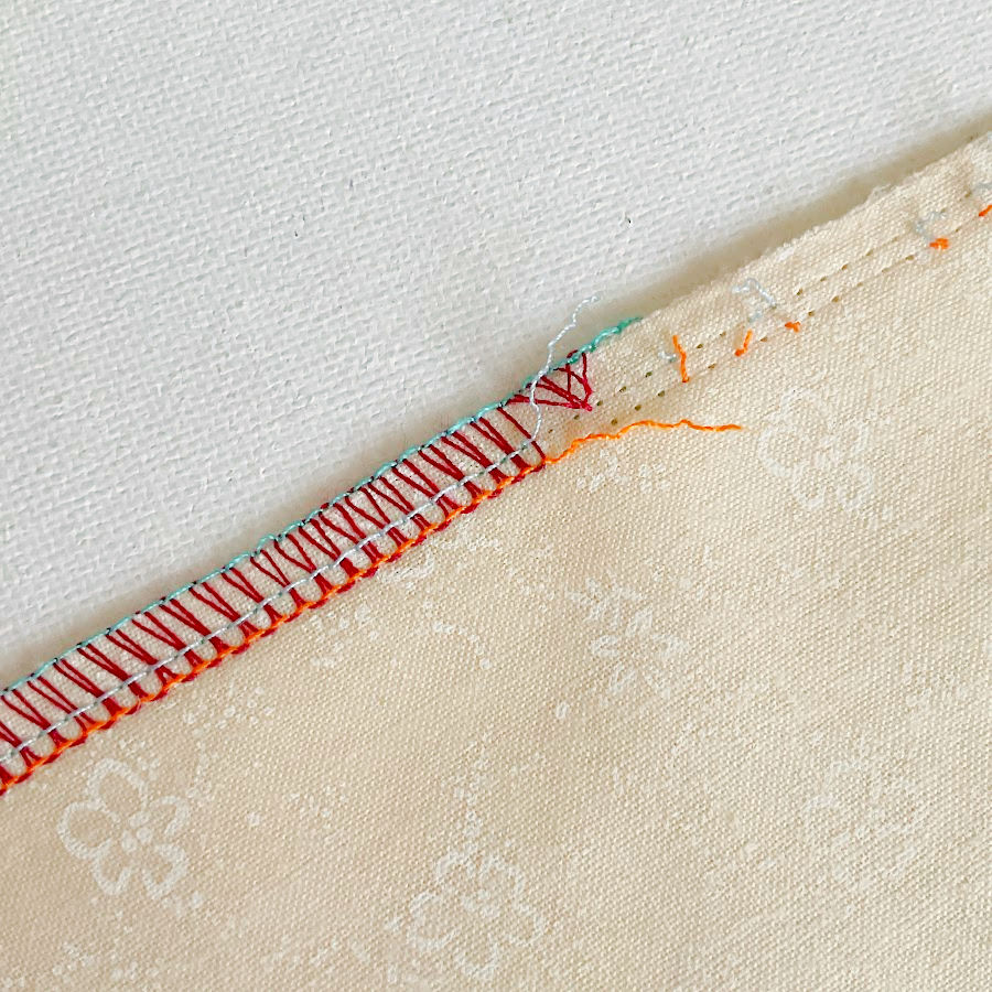 cutting the needle threads at the beginning of the seam and freeing some stitches to allow a thread tail to show