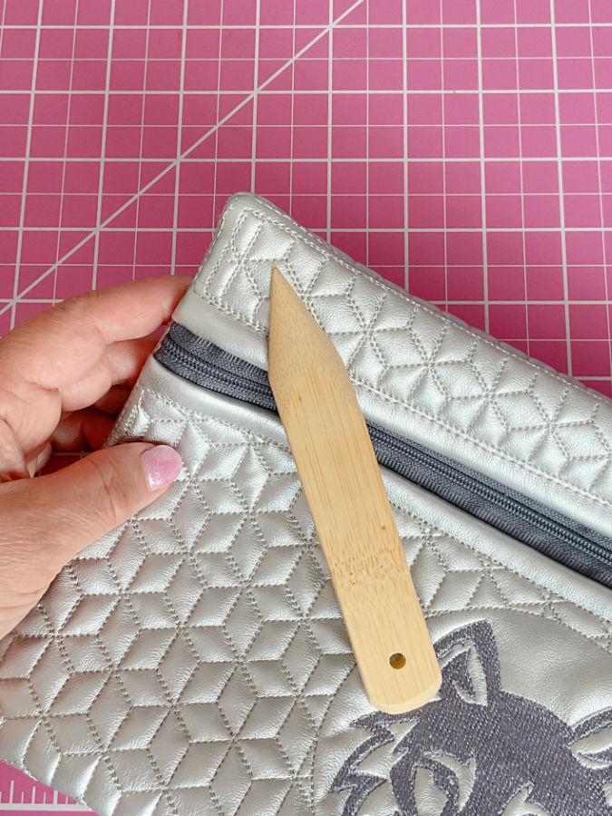 the corner of a zipper popuch and a point turner tool used to turn that corner